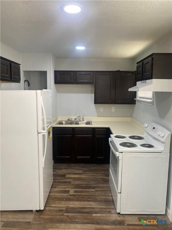 kitchen featuring sink, white appliances, dark brown cabinetry, dark wood-type flooring, and a textured ceiling