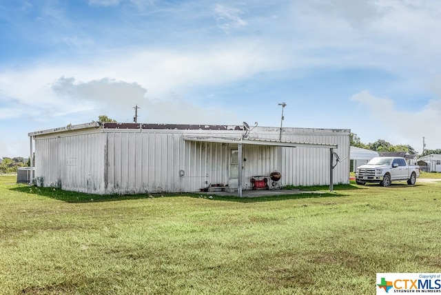 view of outbuilding featuring a yard