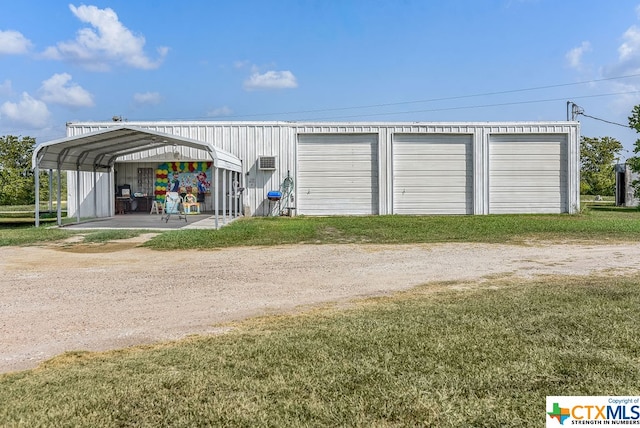 garage featuring a carport and a yard