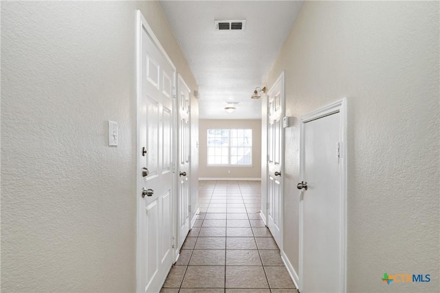 corridor featuring light tile patterned flooring