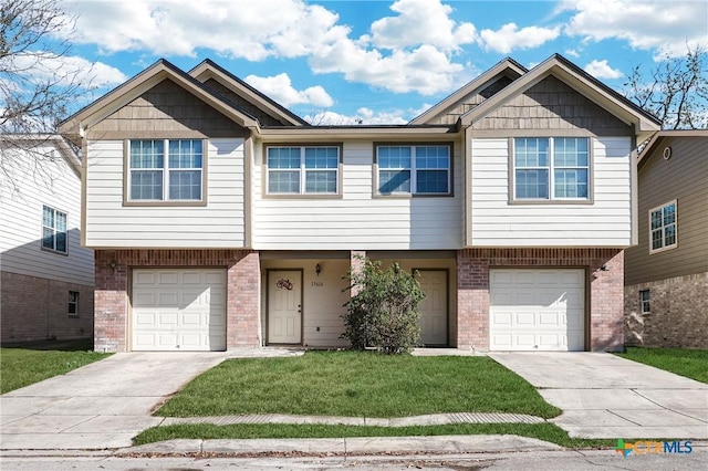 view of front of home featuring a garage and a front yard