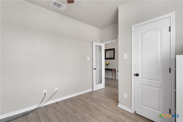 unfurnished room featuring ceiling fan and light wood-type flooring