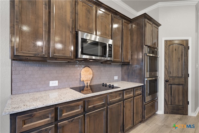 kitchen with stainless steel appliances, decorative backsplash, dark brown cabinetry, crown molding, and light stone countertops