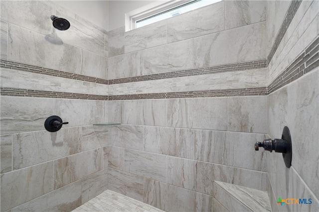 bathroom with a tile shower