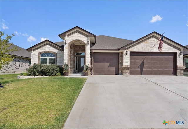 view of front of home featuring a garage and a front yard