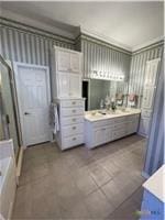 full bathroom with a stall shower, a bath, and vanity