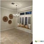 unfurnished dining area with a notable chandelier and crown molding