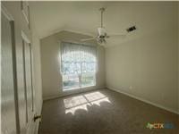 empty room with ceiling fan and baseboards