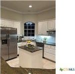 kitchen with a kitchen island and stainless steel fridge with ice dispenser