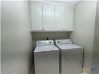 laundry room with cabinet space and washer and clothes dryer