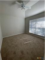 spare room with a ceiling fan and baseboards