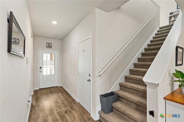 doorway featuring stairs, recessed lighting, wood finished floors, and baseboards