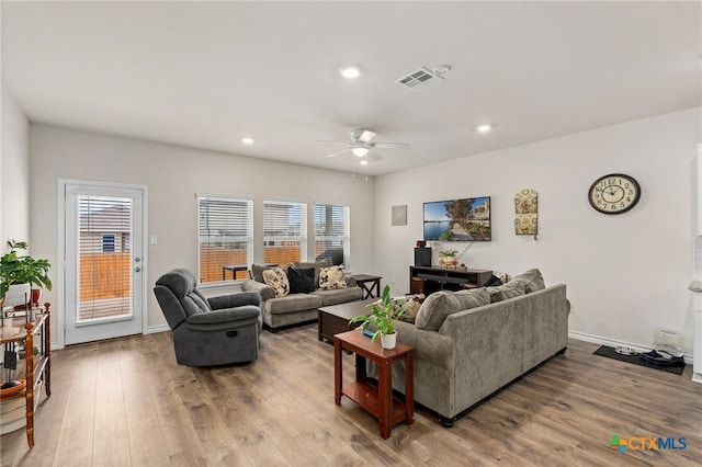 living area with recessed lighting, visible vents, ceiling fan, and wood finished floors