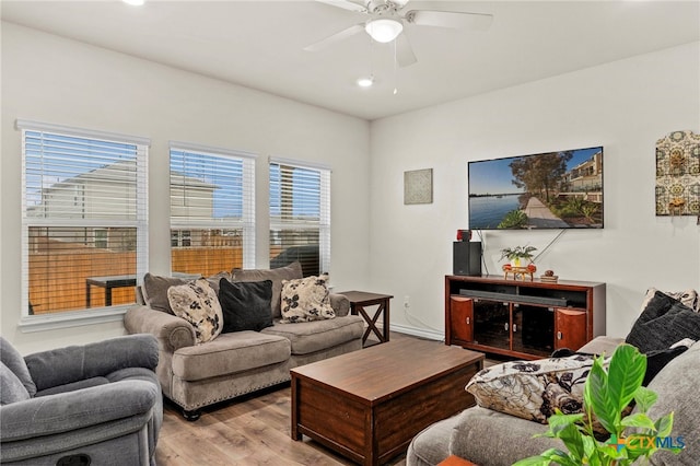 living room featuring a ceiling fan and wood finished floors