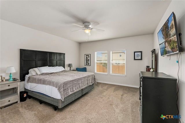 bedroom with ceiling fan, baseboards, and carpet flooring