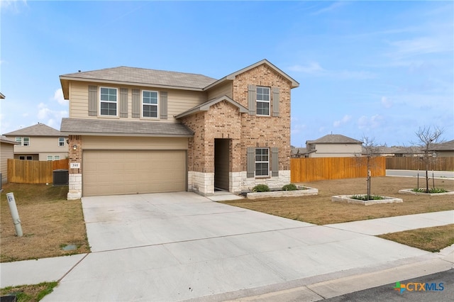 traditional home featuring a garage, concrete driveway, stone siding, fence, and brick siding