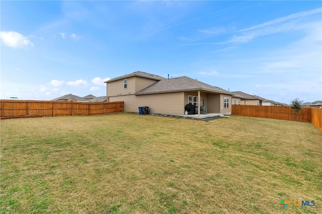 rear view of house featuring a patio area, a fenced backyard, and a lawn