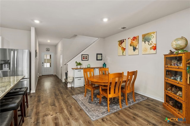 dining area with dark wood-style floors, baseboards, visible vents, and recessed lighting