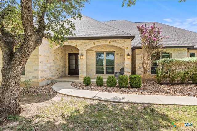 2718 Beaver Ln, New Braunfels, TX 78132 - french provincial home with stone siding, a porch, and a shingled roof