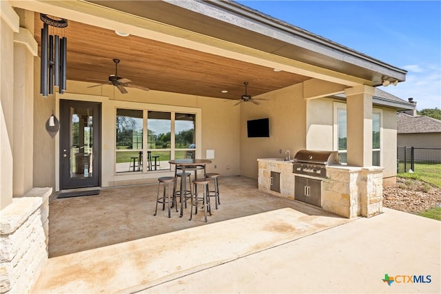 2718 Beaver Ln, New Braunfels, TX 78132 - view of patio with outdoor dining space, exterior kitchen, ceiling fan, and a grill