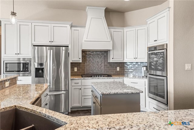 2718 Beaver Ln, New Braunfels, TX 78132 - kitchen with decorative backsplash, custom range hood, light stone countertops, and stainless steel appliances