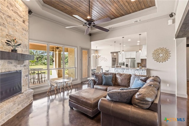 2718 Beaver Ln, New Braunfels, TX 78132 - living area featuring visible vents, concrete floors, wood ceiling, a raised ceiling, and ceiling fan with notable chandelier