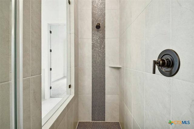 bathroom with a tile shower