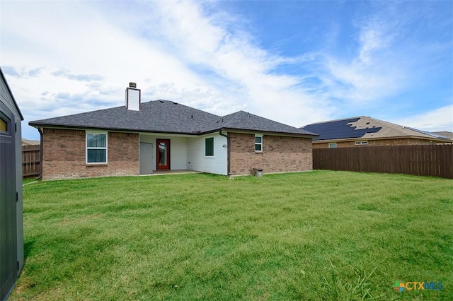 7202 Bose Ikard Dr, Killeen, TX 76549 - rear view of property featuring brick siding, a fenced backyard, a chimney, and a shingled roof