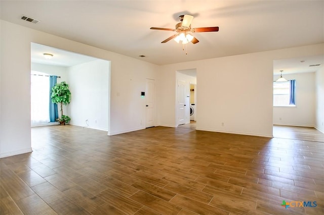 7202 Bose Ikard Dr, Killeen, TX 76549 - unfurnished living room featuring a ceiling fan, dark wood-style flooring, and washer / dryer