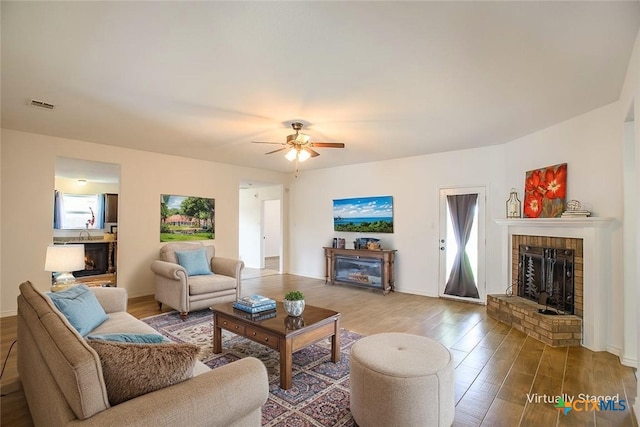 7202 Bose Ikard Dr, Killeen, TX 76549 - living room featuring a brick fireplace, wood finished floors, and a ceiling fan