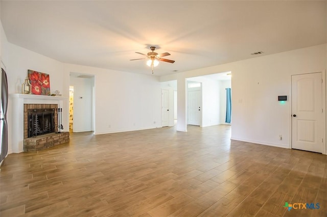 7202 Bose Ikard Dr, Killeen, TX 76549 - unfurnished living room with a ceiling fan, wood finished floors, and a fireplace