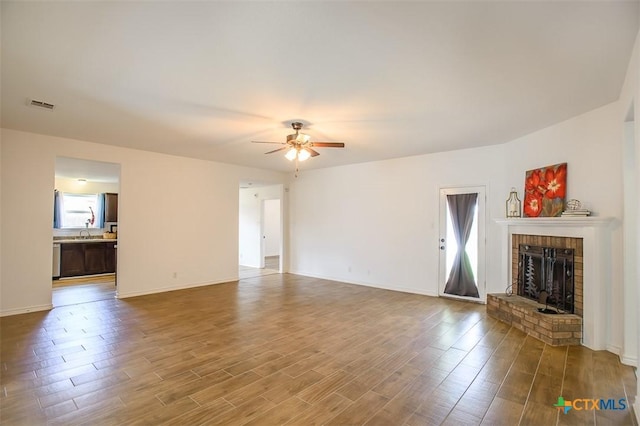 7202 Bose Ikard Dr, Killeen, TX 76549 - unfurnished living room with ceiling fan, wood finished floors, and a brick fireplace