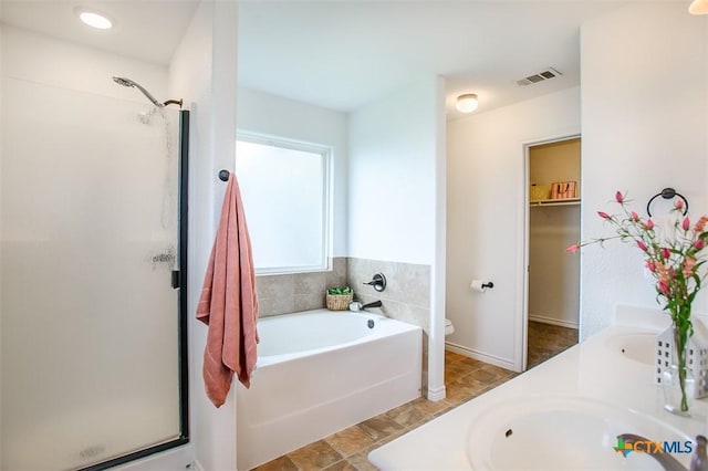 7202 Bose Ikard Dr, Killeen, TX 76549 - bathroom with a shower stall, a bath, double vanity, and a spacious closet