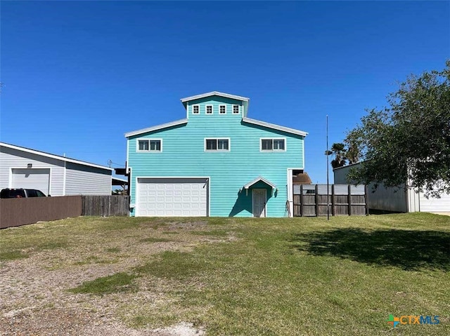 exterior space with a garage and a lawn