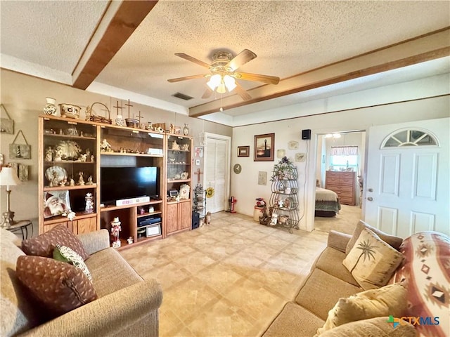 living area with visible vents, a textured ceiling, and ceiling fan