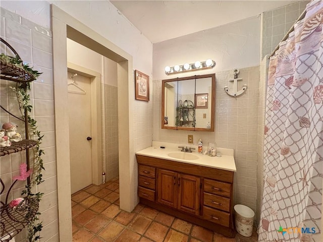 full bath with vanity, a shower with curtain, and tile walls