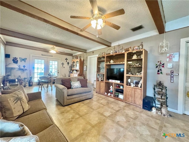 living area with visible vents, a textured ceiling, a ceiling fan, and beam ceiling
