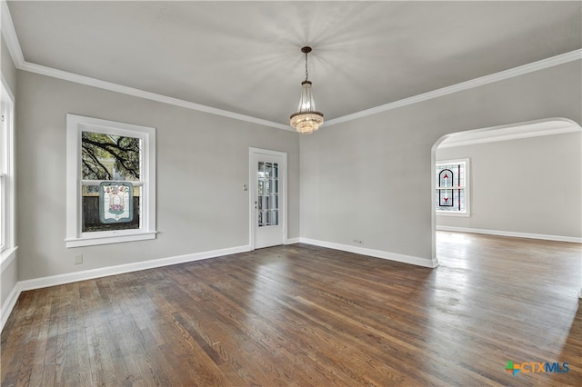 spare room with dark hardwood / wood-style flooring, a chandelier, and crown molding