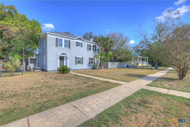 view of front of home featuring central air condition unit and a front lawn