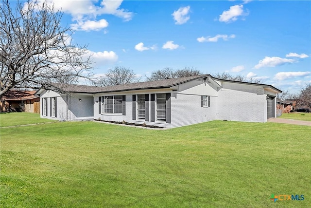 back of property featuring a yard and a garage