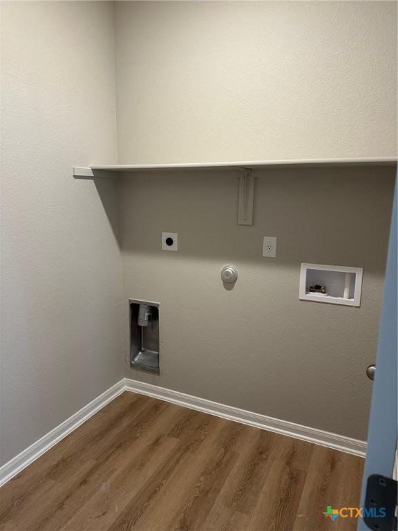 laundry room featuring hookup for a washing machine, gas dryer hookup, hookup for an electric dryer, and hardwood / wood-style floors