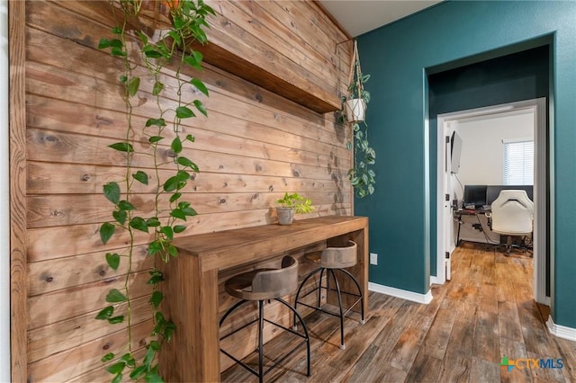 bar with wood finished floors and baseboards