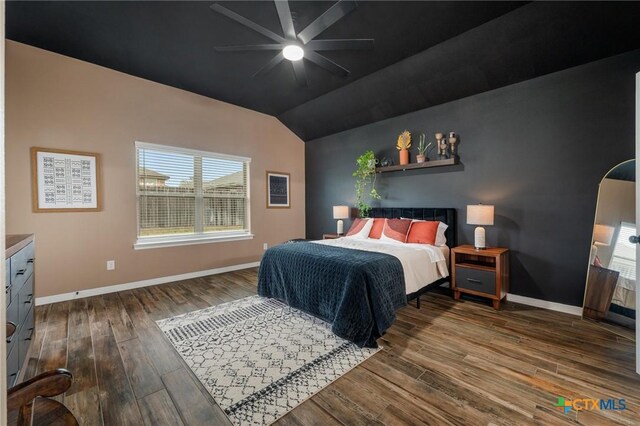 bedroom featuring lofted ceiling, ceiling fan, wood finished floors, and baseboards