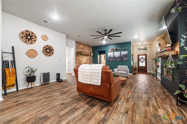 kitchen with white cabinets, stainless steel microwave, decorative backsplash, and dark wood-type flooring