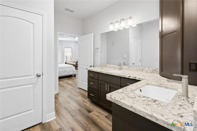 267 Oak View Dr, Inez, TX 77968 - bathroom with wood finished floors, double vanity, and connected bathroom