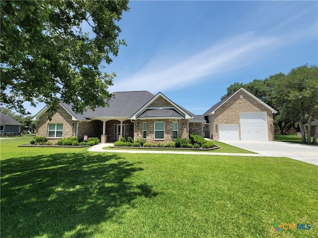 267 Oak View Dr, Inez, TX 77968 - view of front facade with driveway, a front lawn, brick siding, and a garage