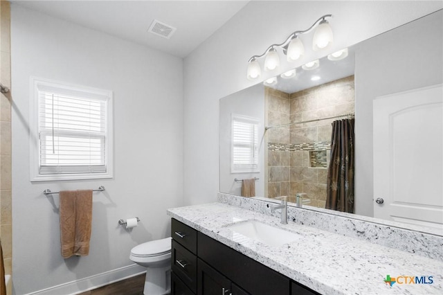 267 Oak View Dr, Inez, TX 77968 - bathroom with tiled shower, toilet, vanity, and baseboards