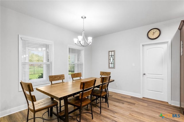 267 Oak View Dr, Inez, TX 77968 - dining area with a chandelier, light wood-type flooring, and baseboards