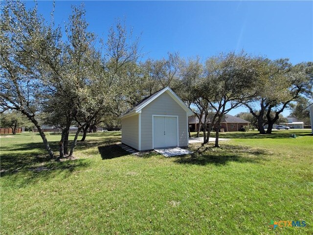 267 Oak View Dr, Inez, TX 77968 - view of green lawn with a storage unit and an outbuilding