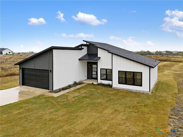 modern farmhouse featuring a garage and a front yard